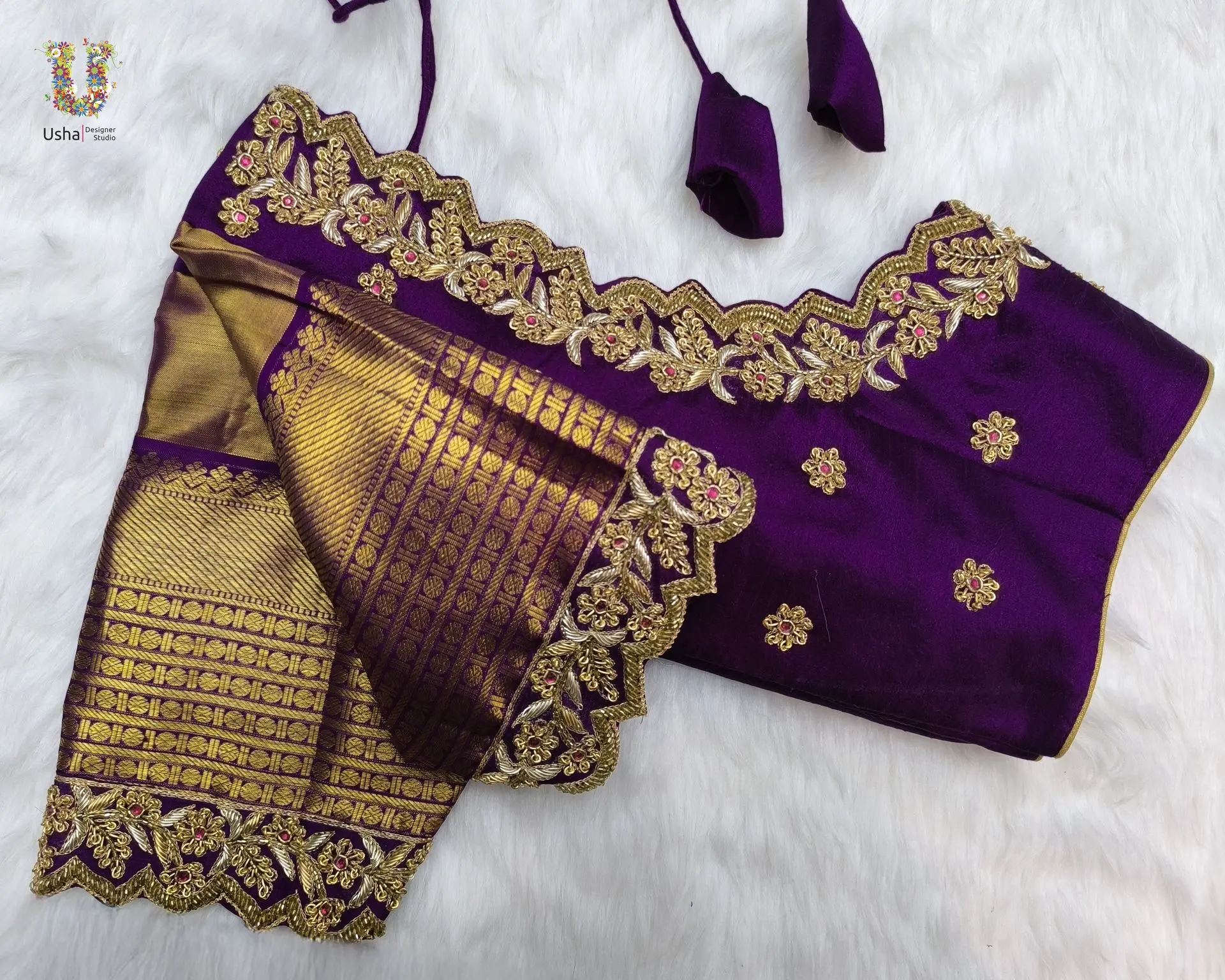 Royal purple blouse featuring rich gold zari weaving and delicate aari floral embroidery with scalloped borders, by Usha Designer Studio