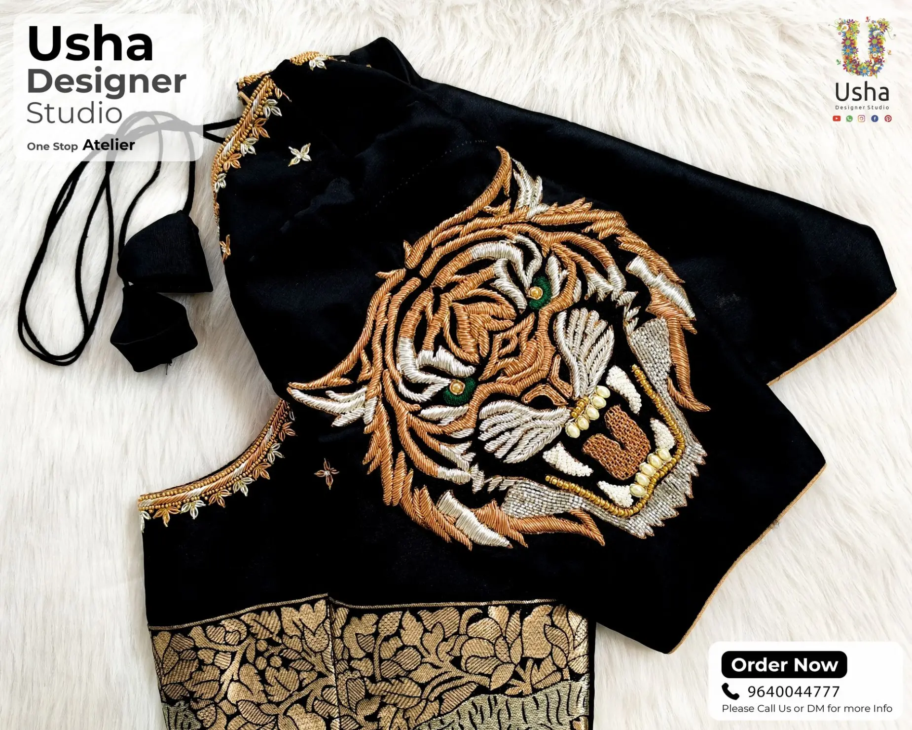 custom-designed bridal blouse by Usha Designer Studio, featuring intricate Aari and Maggam work of a roaring tiger's face on the back. The detailed embroidery uses gold, orange, and white thread, with green eyes. The blouse has a traditional gold brocade border.