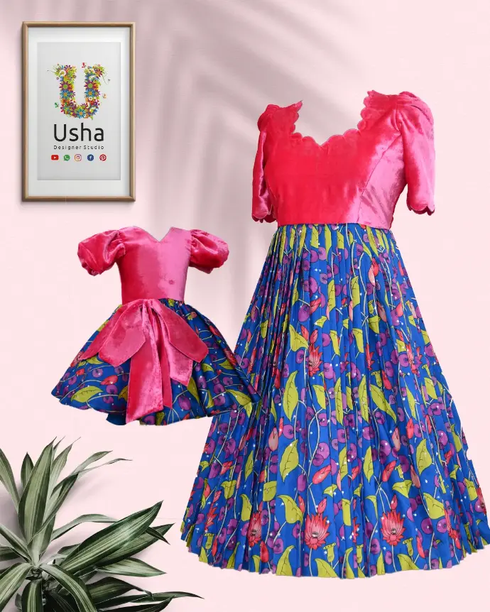 Mother and daughter dressed in matching outfits by Usha Designer Studio, featuring soft Muqmal (velvet) and vibrant Kalamkari printed fabric with scalloped neckline and sleeve edges, embellished with intricate Butta motifs—blending traditional Indian artistry and contemporary design.