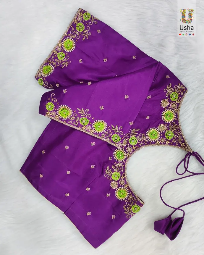 Intricate Aari embroidery on a tailor-made blouse by Usha Designer Studio, Vijayawada. Showcases detailed hand-stitched floral motifs with beads and sequins.