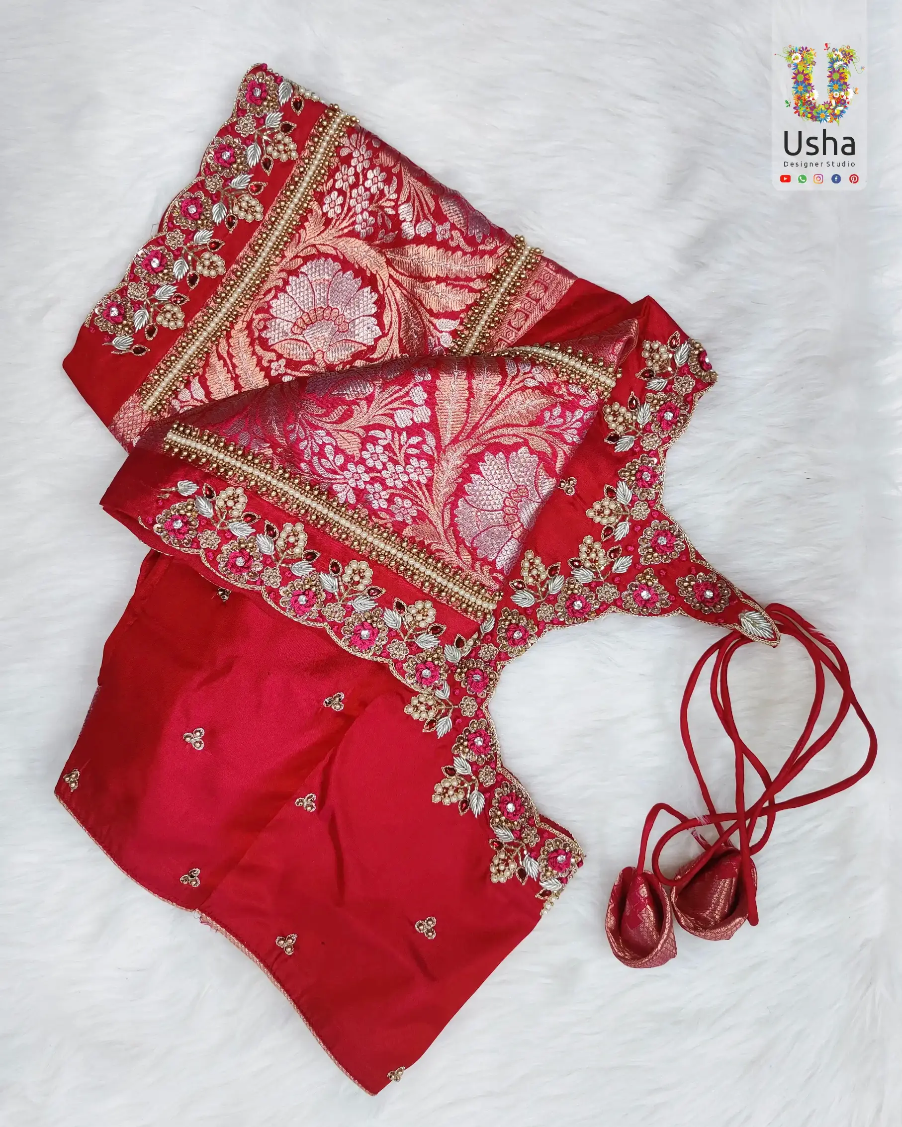Red bridal Aari blouse with detailed gold and pink embroidery, beadwork, and pot neck design, custom-tailored by Usha Designer Studio Vijayawada