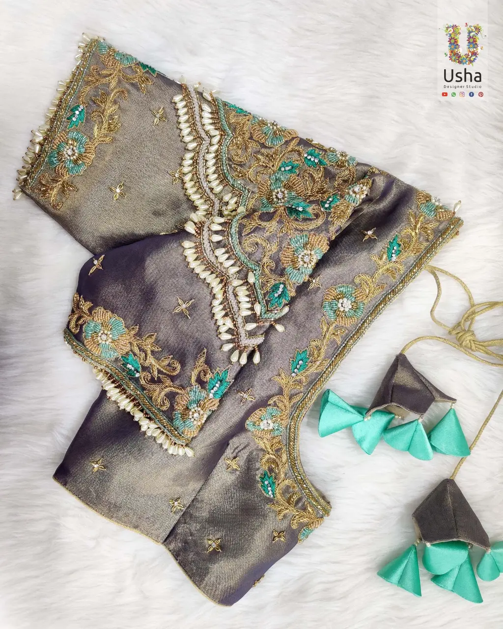Elegant Taupe Bridal Aari Embroidery Blouse – Usha Designer Studio, Vijayawada Taupe bridal blouse with intricate gold and turquoise Aari embroidery, pearl bead edging, and designer tassels by Usha Designer Studio, Vijayawada