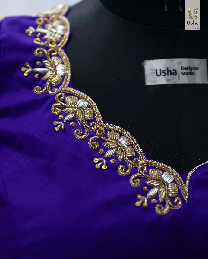 Purple Paithani crop top lehenga with Aari hand embroidery, scalloped U-neck, pleated lehenga, handcrafted latkans, and Maggam-edged Paithani dupatta by Usha Designer Studio, Vijayawada.