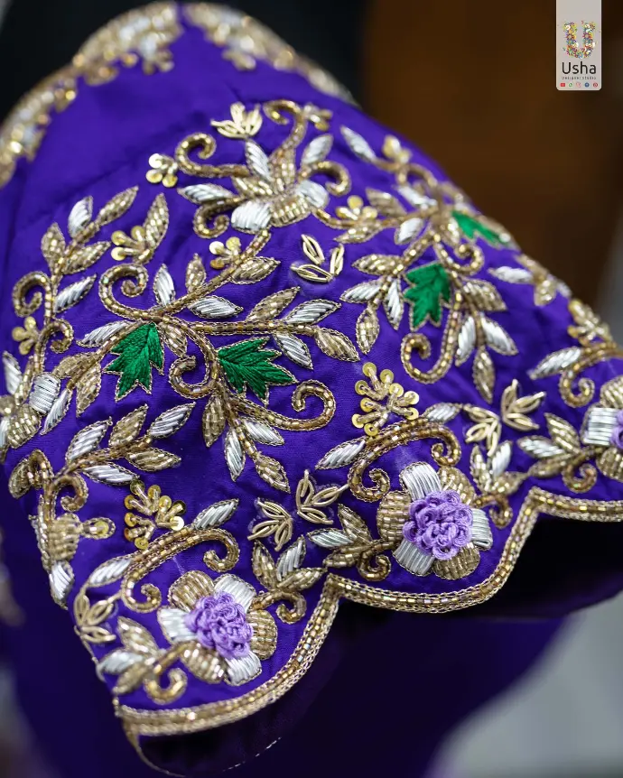 Purple Paithani crop top lehenga with Aari hand embroidery, scalloped U-neck, pleated lehenga, handcrafted latkans, and Maggam-edged Paithani dupatta by Usha Designer Studio, Vijayawada.