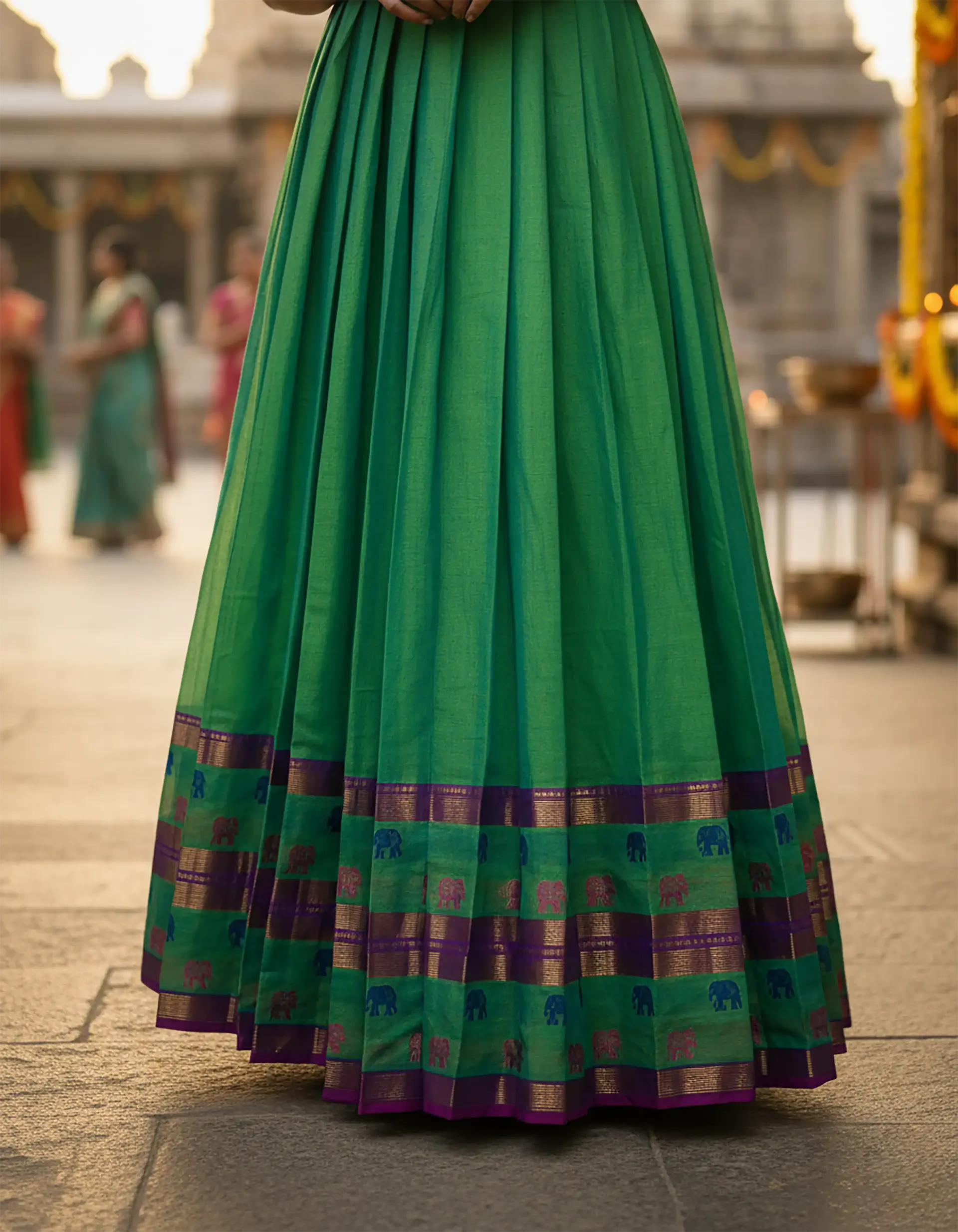 Green boat-neck long frock with elbow sleeves and 1-inch pleats, crafted from Narayanapet cotton by Usha Designer Studio, Vijayawada.