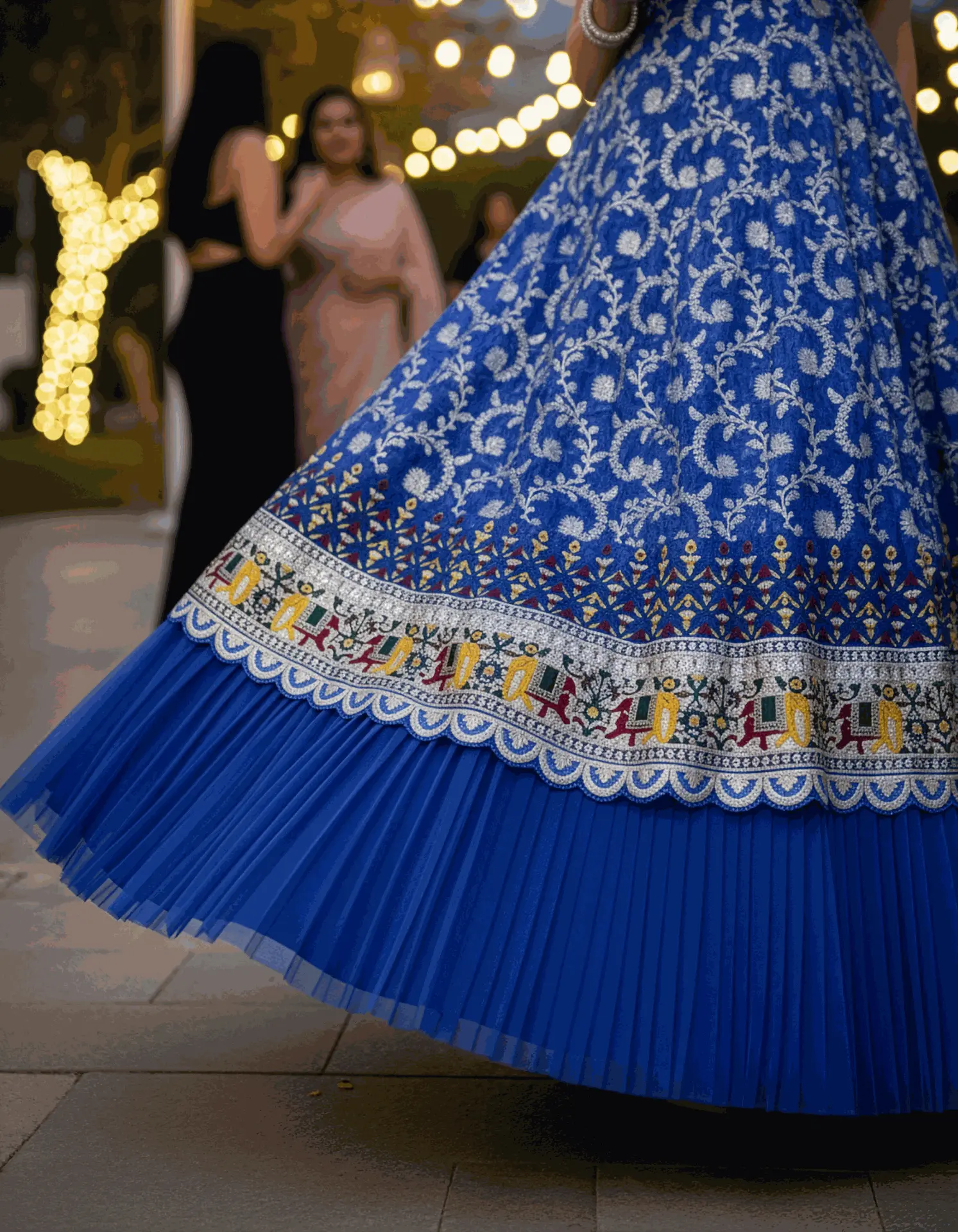 Tailor-made blue Dola silk long frock with scalloped U-neck, soft net ruffle sleeves, and intricate border embroidery by Usha Designer Studio, Vijayawada
