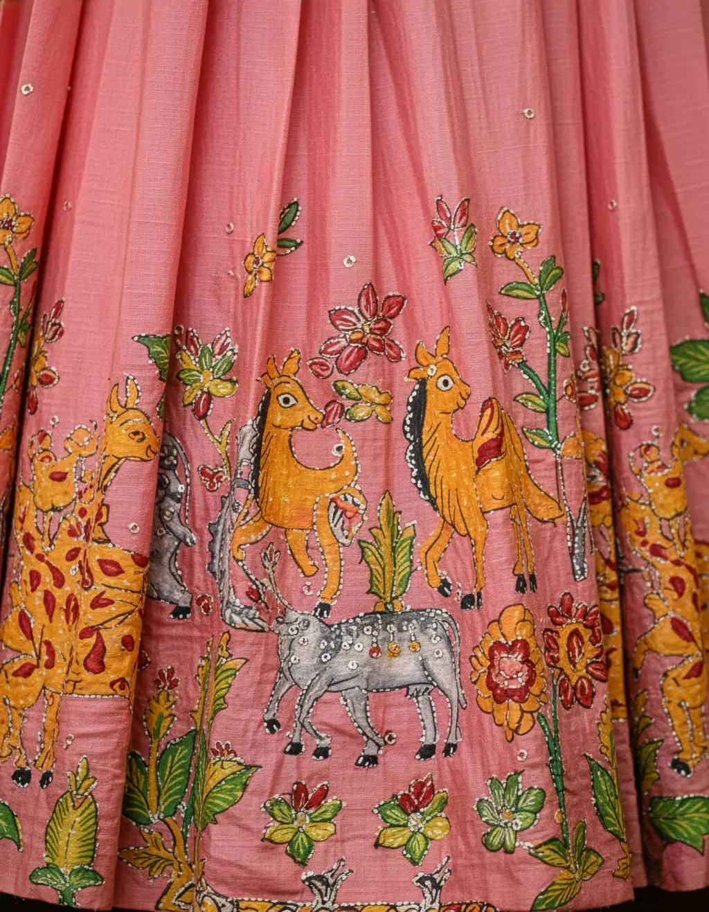 Kids tailor-made peplum crop top blouse with scalloped U-neck and intricate Aari embroidery paired with pink jungle-themed hand-painted lehenga with sequins