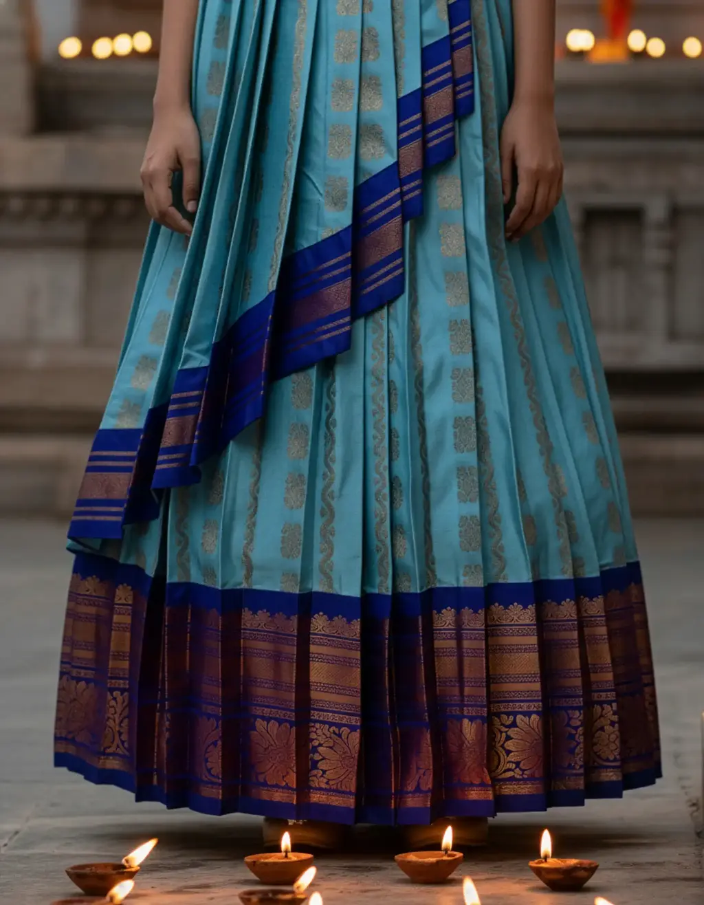 Pure Pattu Saree upcycled into designer kids long frock with U-neck, pleated balloon sleeves, and generous layered pleats in vivid blue and gold silk.