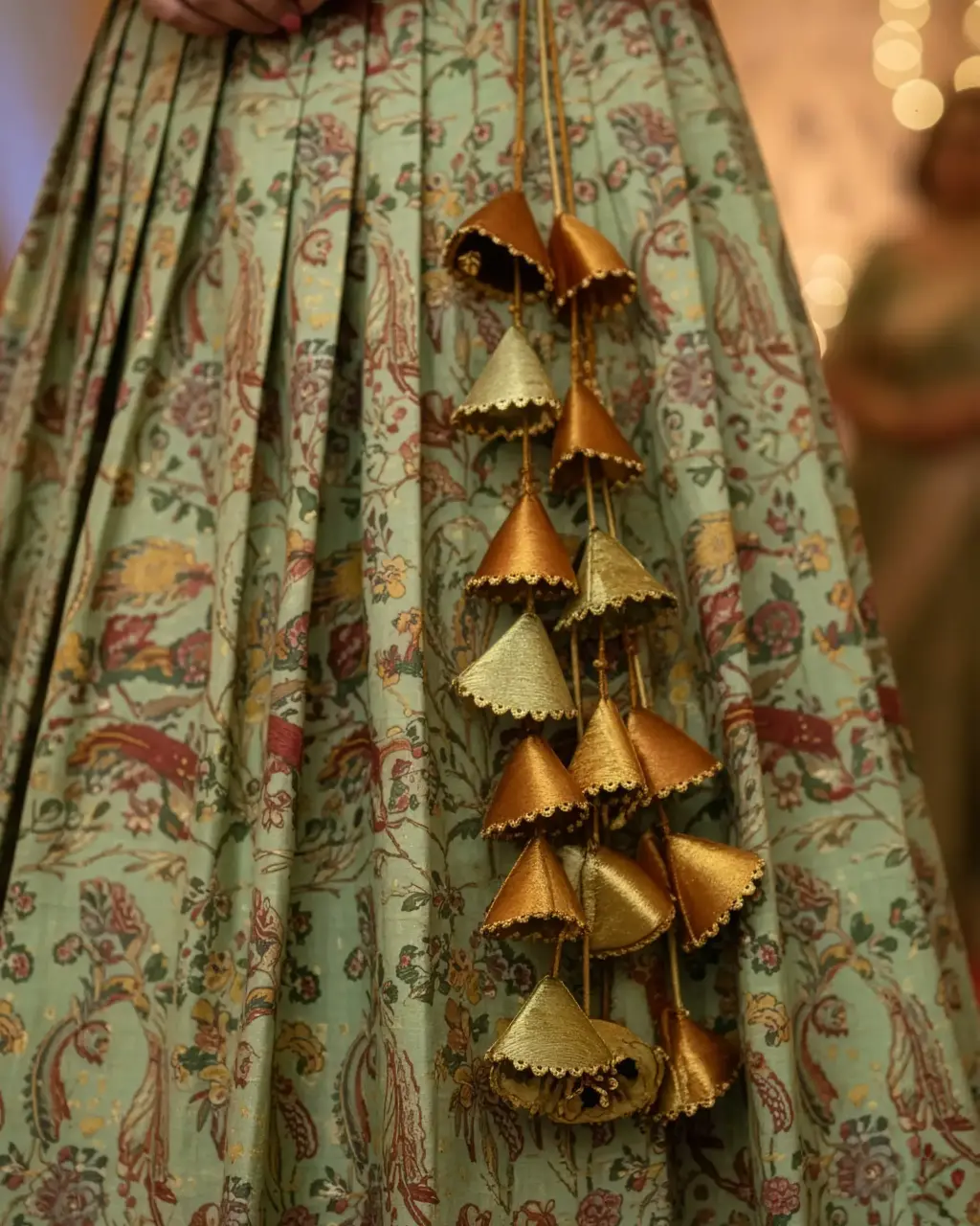 Tailor-made olive green Kanchi pattu lehenga set with U-neck Aari-work blouse and peacock motifs, styled with handcrafted heavy latkans by Usha Designer Studio, Vijayawada.