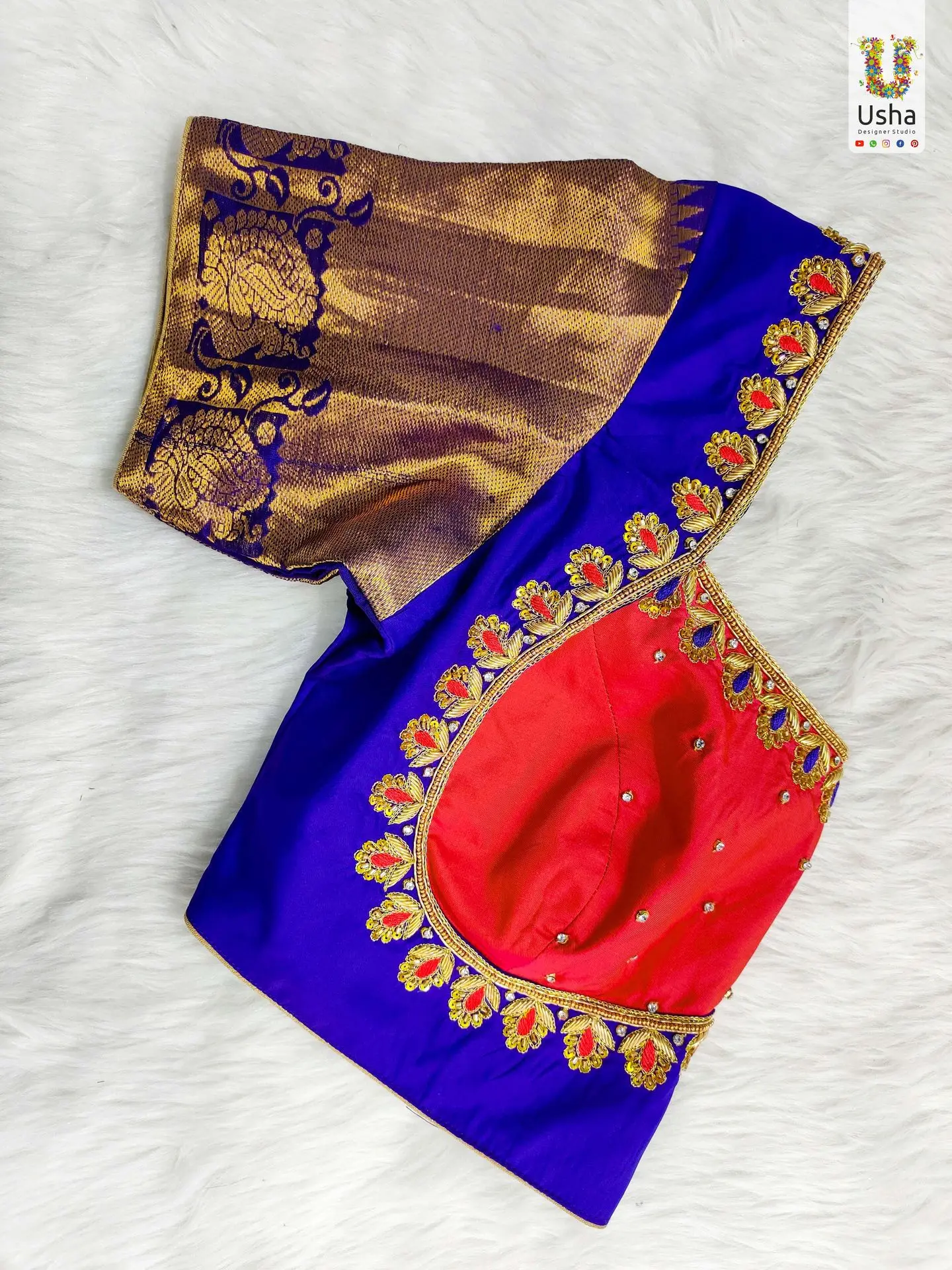 Red & Blue Bridal Aari Work Blouse – Handcrafted Designer by Usha Designer Studio, Vijayawada Elegant red and blue bridal blouse with intricate Aari embroidery and gold detailing, handcrafted by Usha Designer Studio, Vijayawada