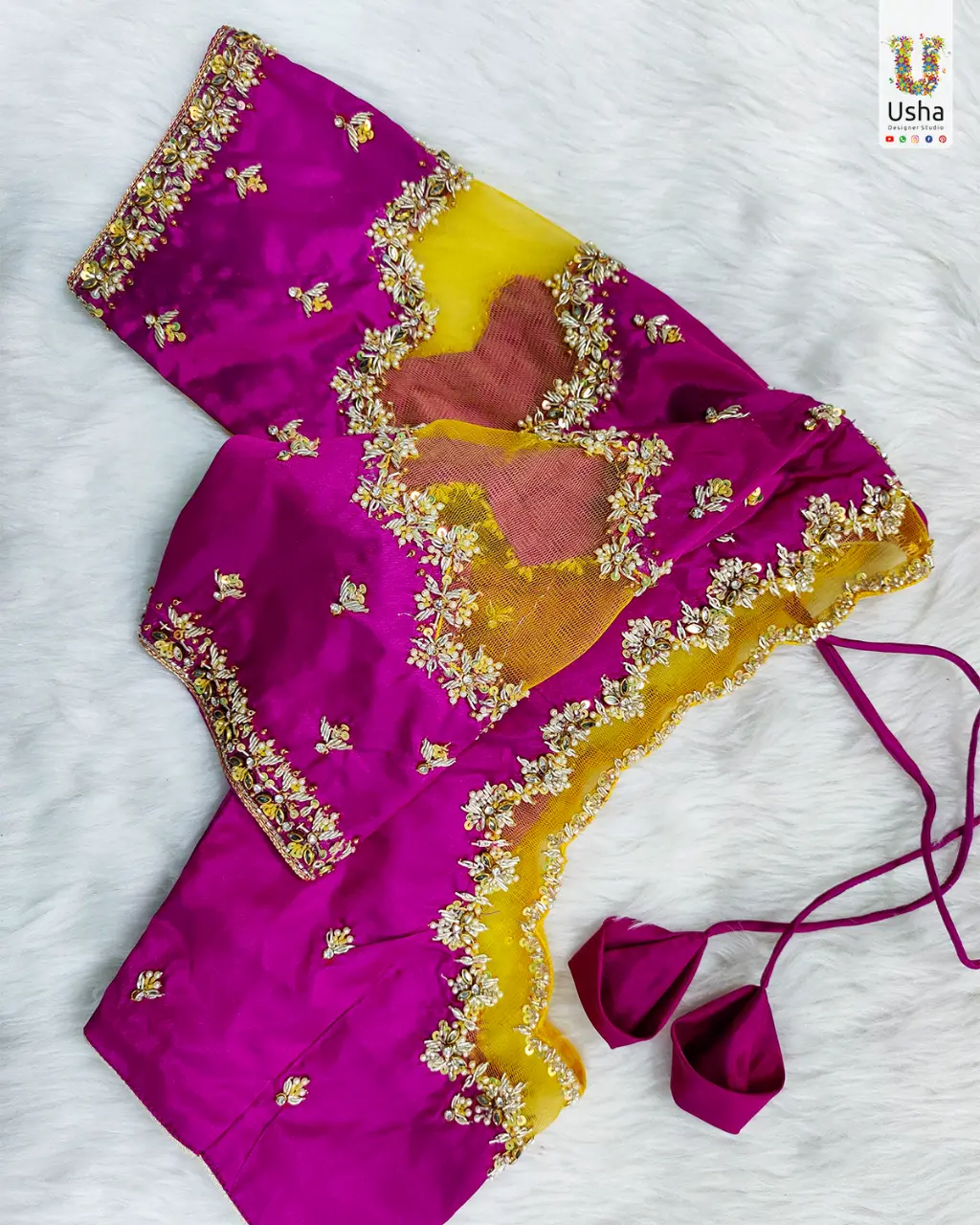 Bridal Magenta Pattu Blouse with Yellow Soft Net & Intricate Aari Work – Usha Designer Studio Vijayawada Magenta pure pattu bridal blouse with yellow soft-net back, heavy hand Aari floral embroidery and tassel tie-ups by Usha Designer Studio Vijayawada
