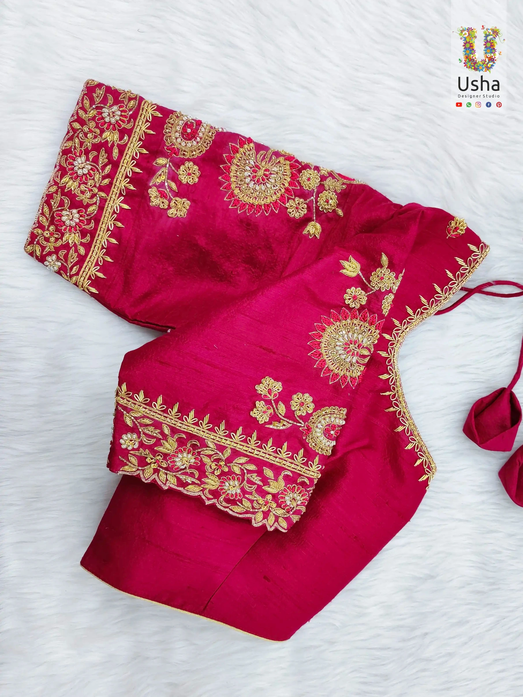 Rani pink raw silk blouse with intricate gold Aari embroidery floral motifs and scalloped borders, custom-tailored bespoke bridal outfit by Usha Designer Studio, Vijayawada.