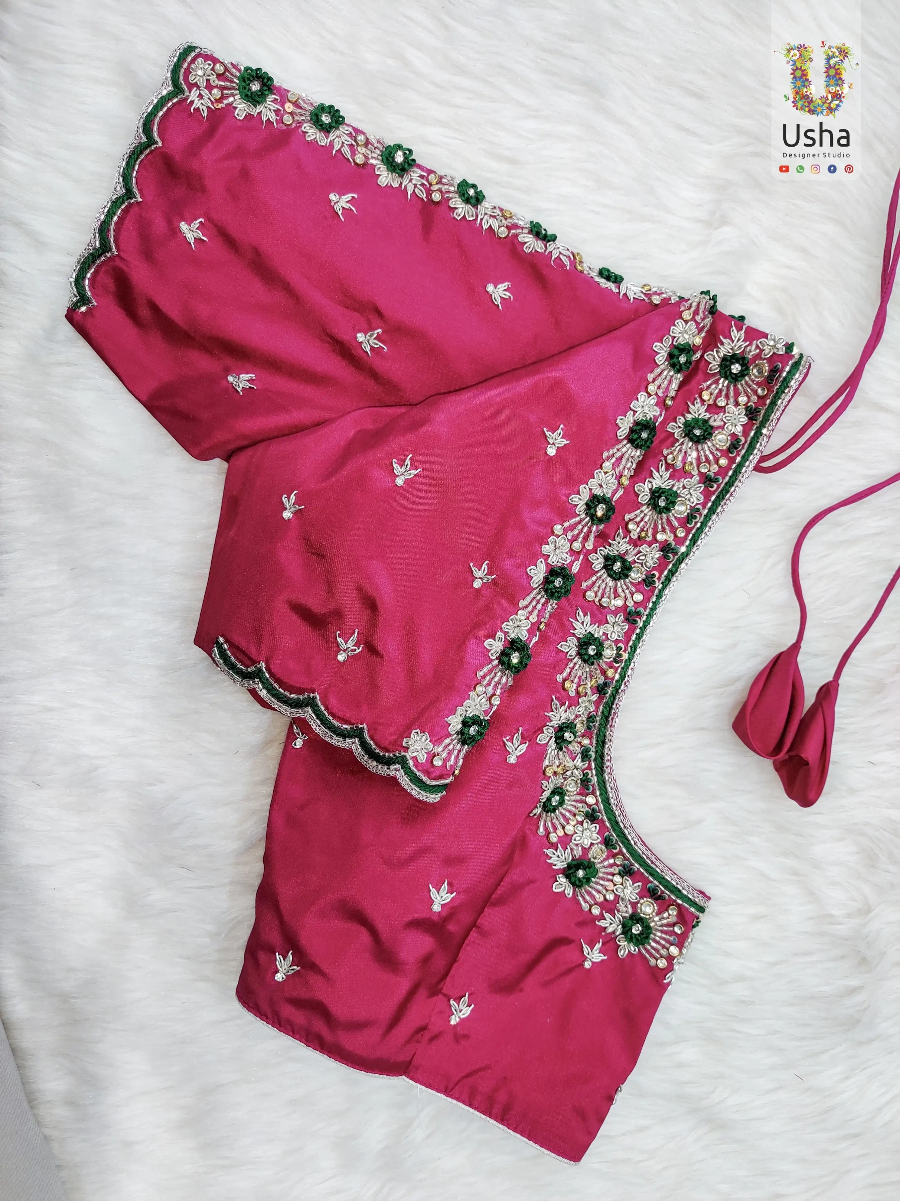 Magenta designer blouse with intricate green floral Aari embroidery and silver beadwork by Usha Designer Studio Vijayawada.