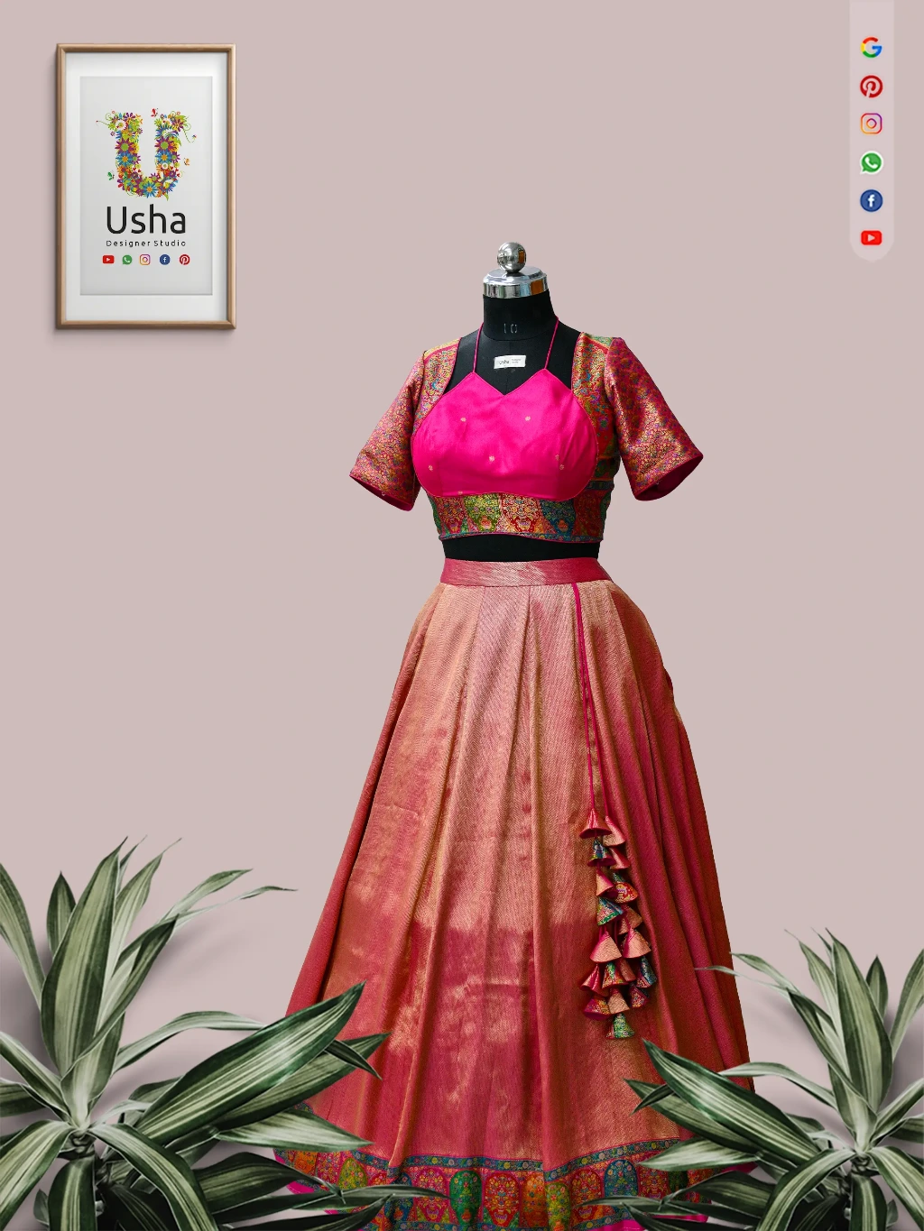 bespoke upcycled saree to pink silk crop top lehenga with colorful patterned borders and large handcrafted tassels, standing in an ancient South Indian carved stone temple. Designed by Usha Designer Studio, Vijayawada.
