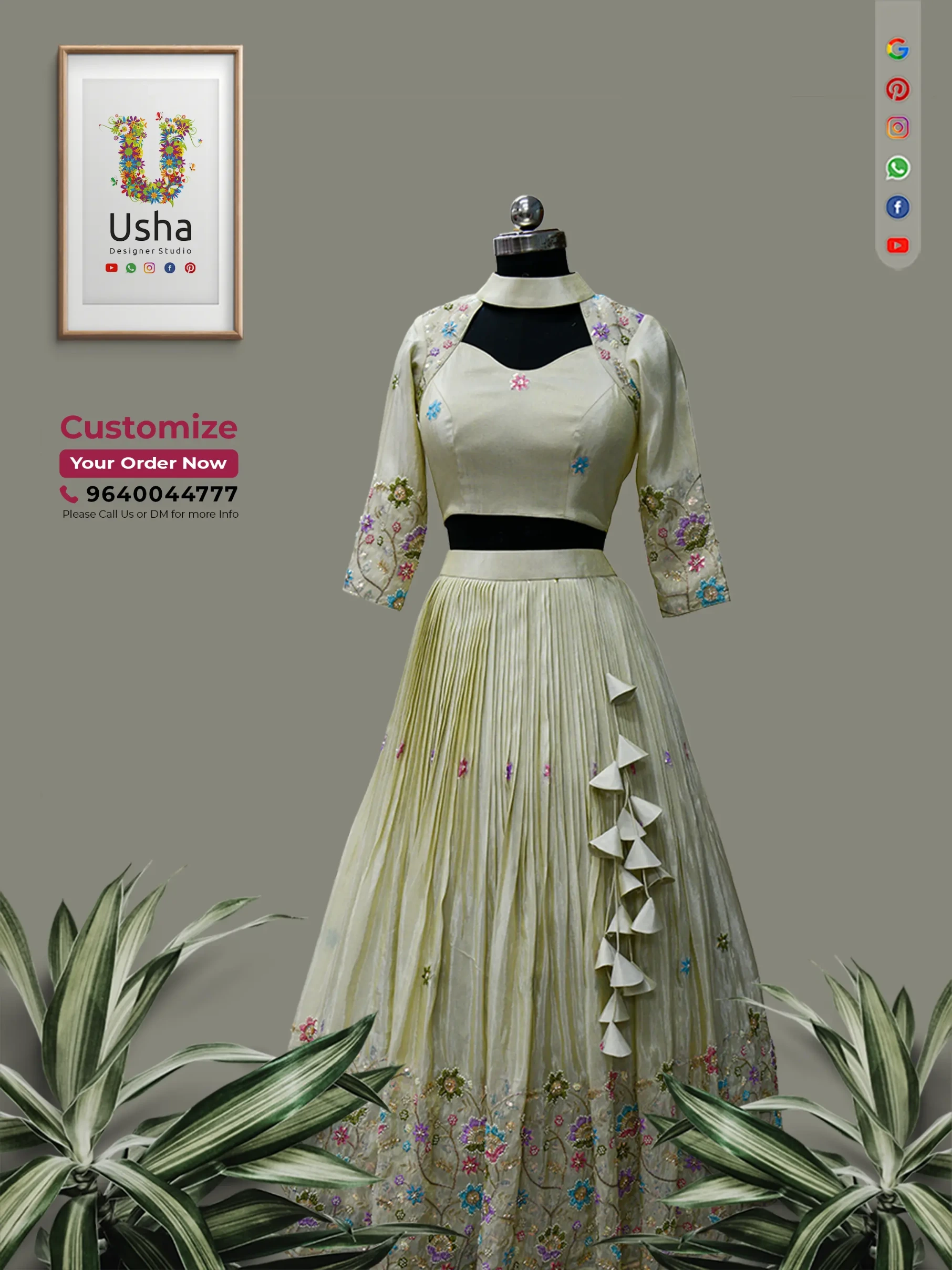 Pastel yellow designer pleated lehenga skirt and choker neck crop top set with multicolor floral embroidery displayed on a mannequin at Usha Designer Studio in Vijayawada.
